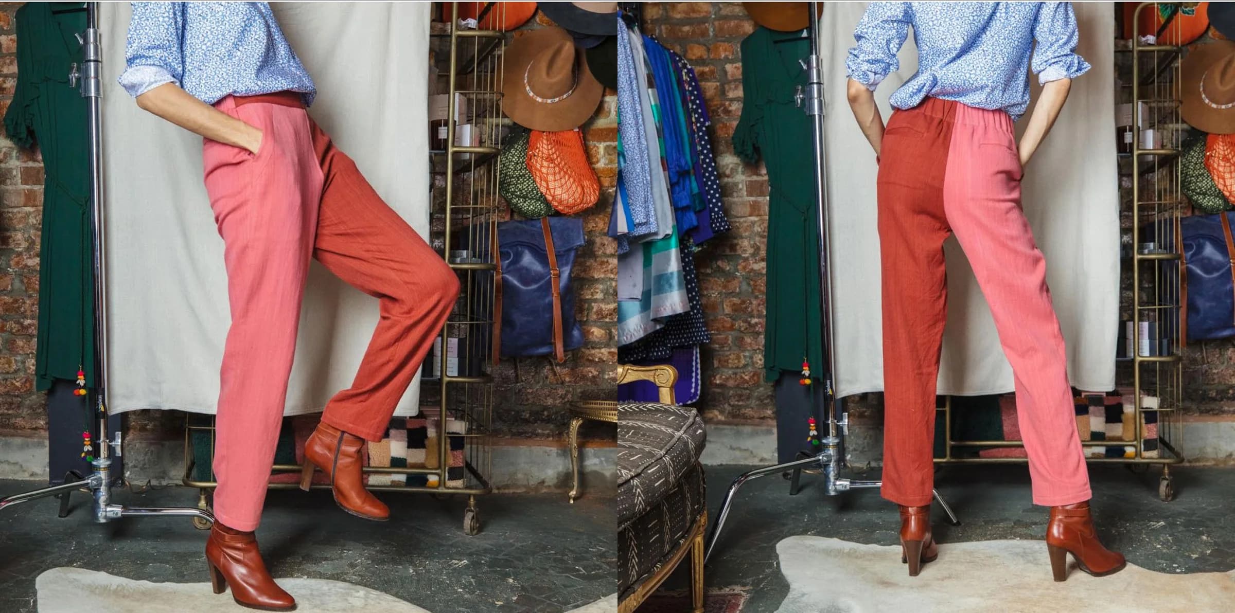 Inside the boutique — a model in coral trousers, hats and bags hanging on the brick wall behind.